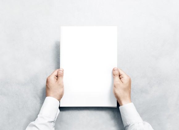 Academic holds a blank piece of paper