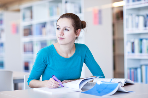 Female student engages in research in university library