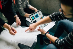 Graduate data analysts meet to discuss a project