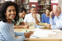 Group of academics share research in public library 