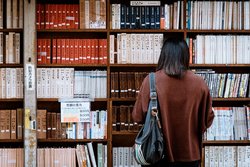 Student looks for a research book in university library
